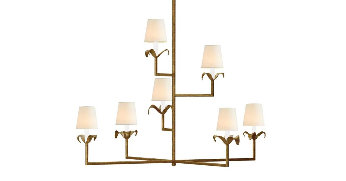 A farmhouse-style master bathroom with a clear glass shower, white cabinets and counters, and box-style chandeliers.