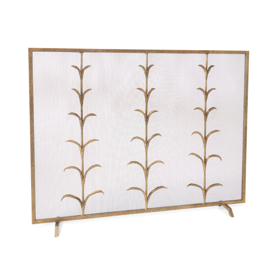 A gold-colored metal fireplace screen featuring a botanical design with lily stems.