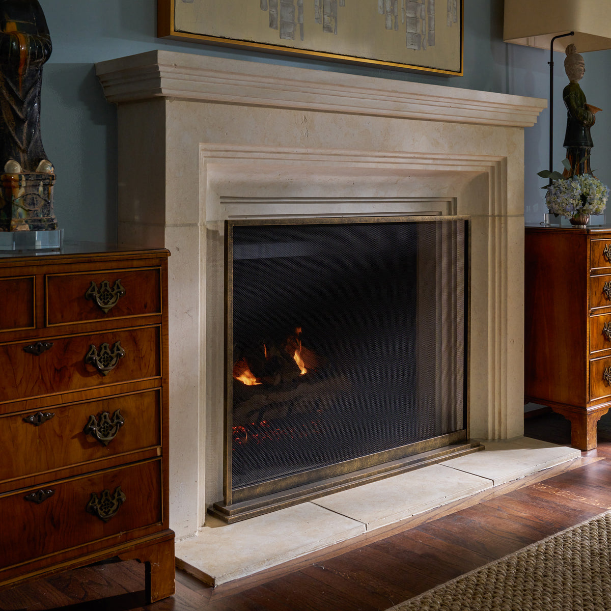 Hand-finished August fireplace screen installed at a limestone fireplace