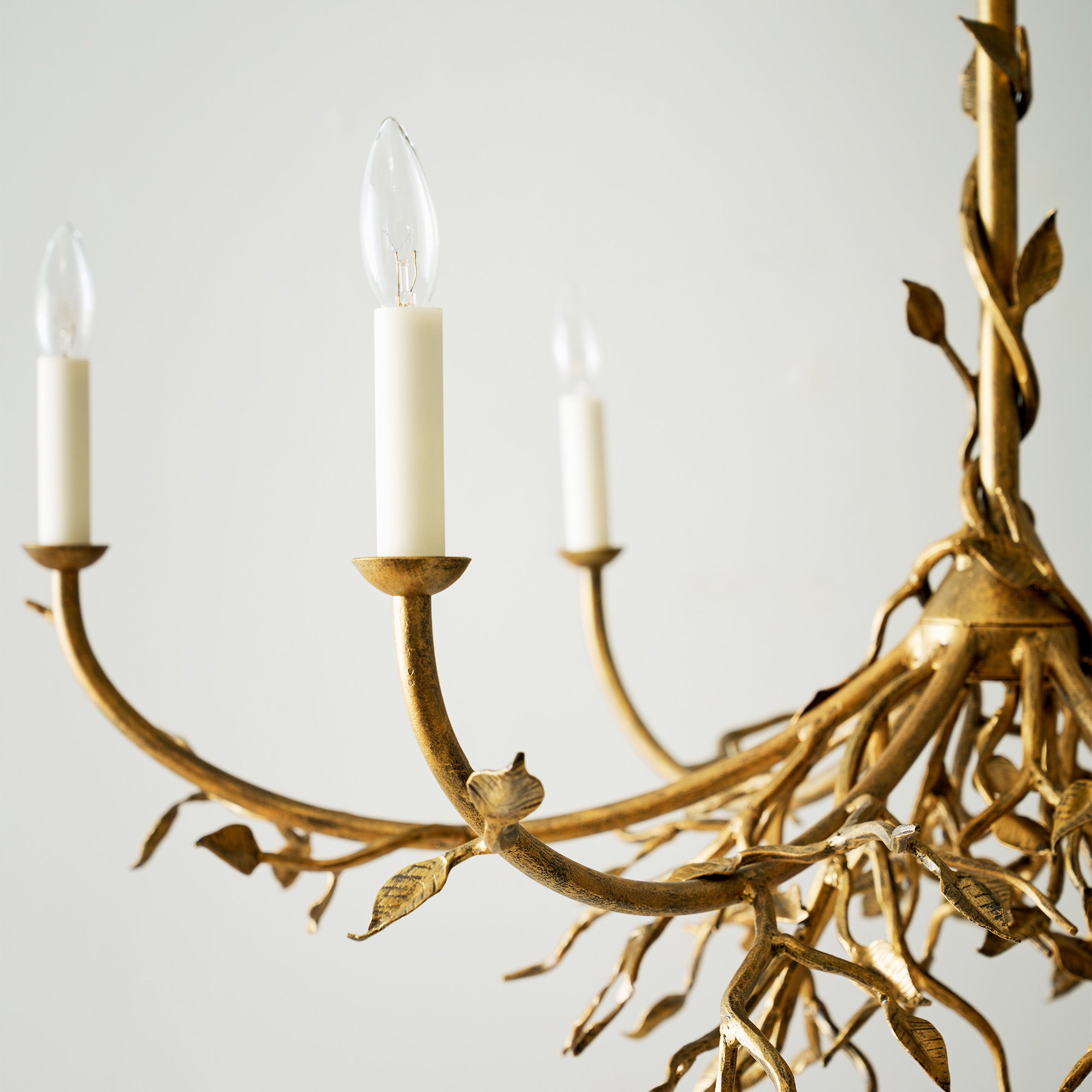 Elegant lennox branching chandelier with branch like design and candle shaped bulbs in a gold finish.