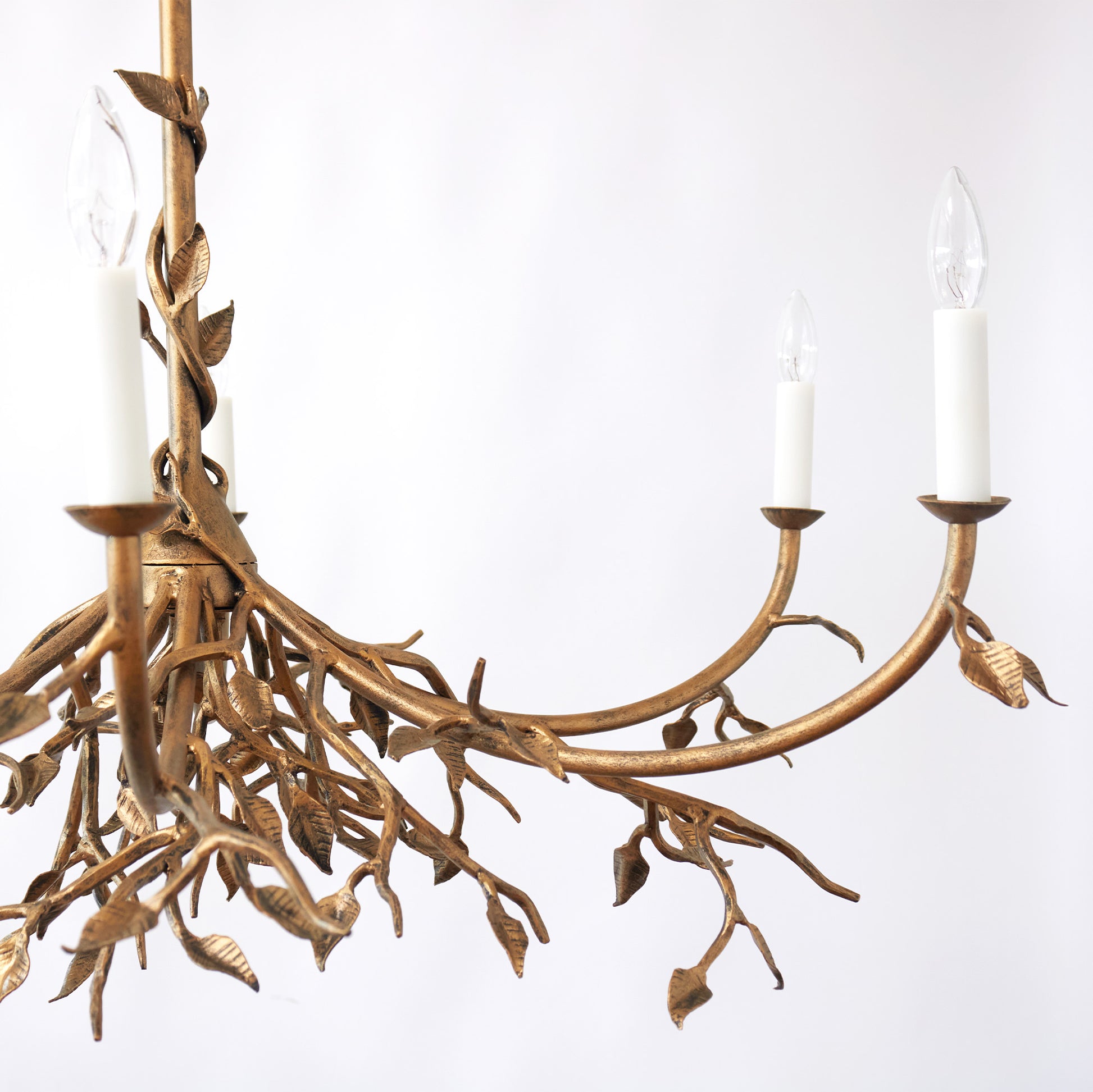 Custom lennox branching chandelier detail showing intricate, leaf like metal branches, elegantly twisting against a white background, by Claire Crowe Collection.