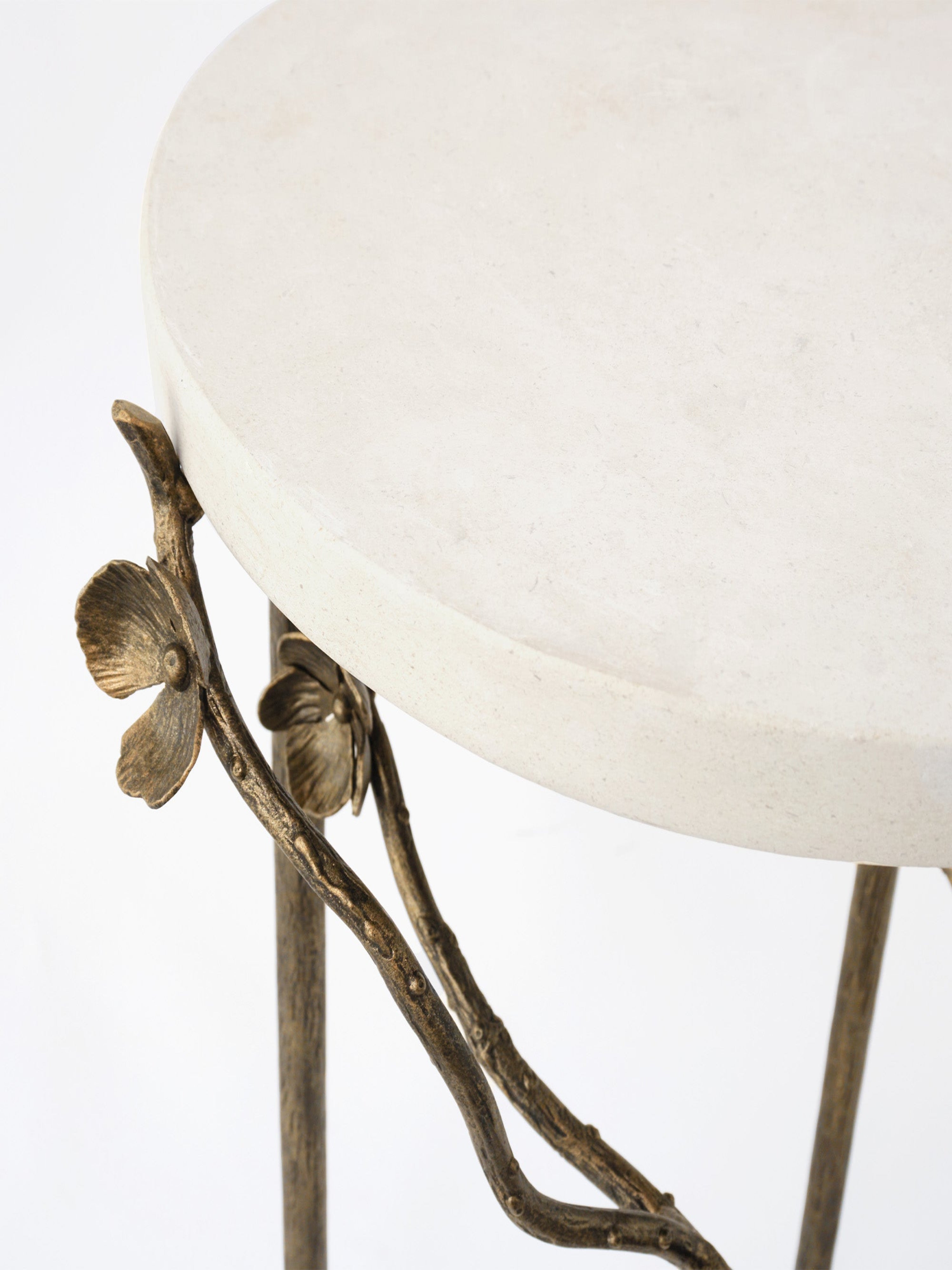 Cherry blossom accent table featuring round white marble tabletop supported by bronze floral branch legs, showcasing intricate petal details, by Claire Crowe Collection.