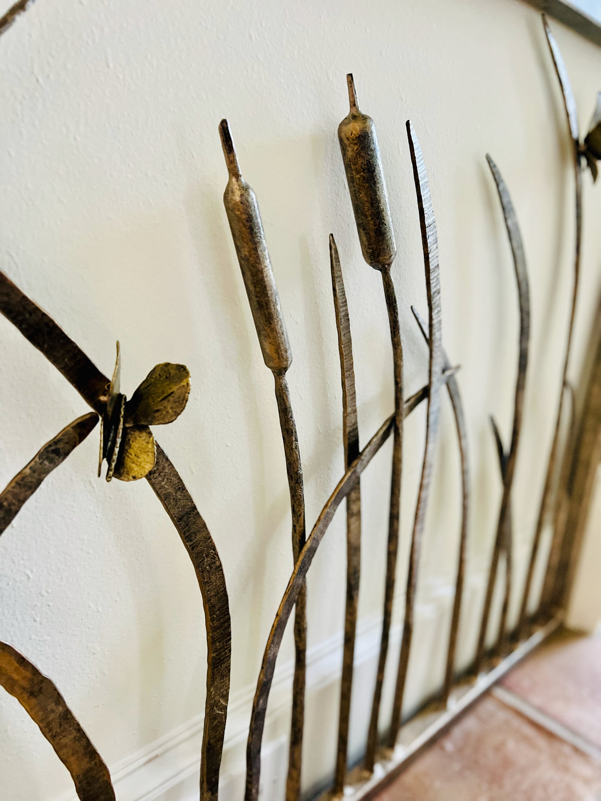 Custom panel with hand-forged reeds, cattails, and a butterfly
