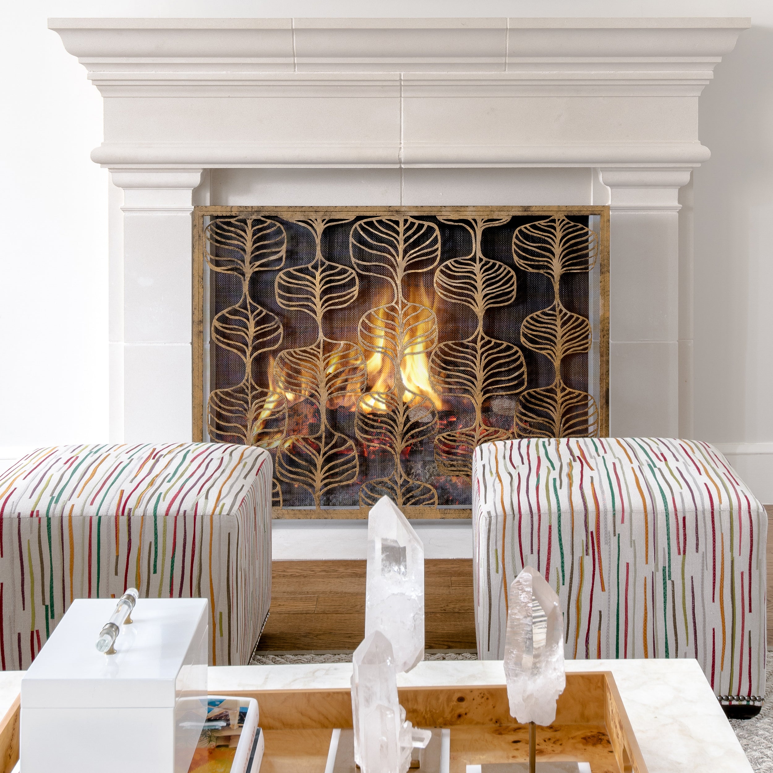 Fig Leaf Fireplace Screen in front of fireplace with multi-colored ottomans 